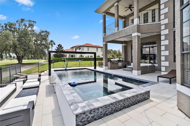 view of pool with an outdoor hangout area, a patio area, an outdoor kitchen, and a yard