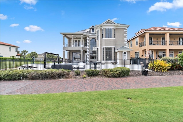 back of property featuring a yard and a balcony