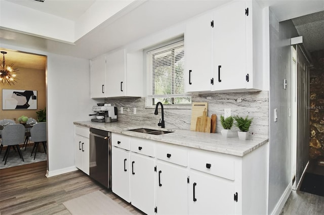 kitchen with stainless steel dishwasher, sink, white cabinets, and dark hardwood / wood-style flooring