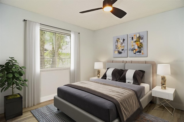 bedroom with light wood-type flooring, a textured ceiling, and ceiling fan