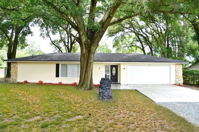 ranch-style house featuring a garage and a front lawn