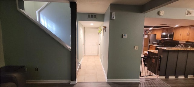 corridor featuring light tile patterned floors