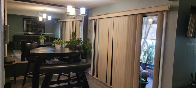 dining room featuring hardwood / wood-style flooring and a chandelier