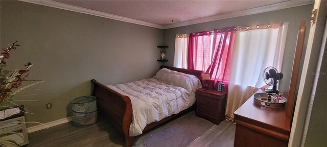 bedroom featuring a textured ceiling, crown molding, and hardwood / wood-style flooring