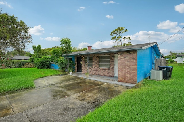 single story home featuring a patio area, central air condition unit, and a front lawn