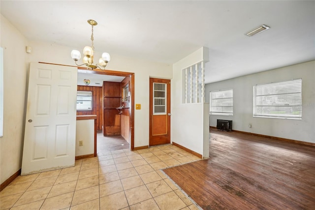 interior space with an inviting chandelier and light tile patterned floors