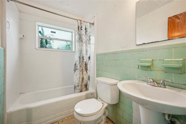 full bathroom with tile walls, sink, shower / bath combination with curtain, and toilet