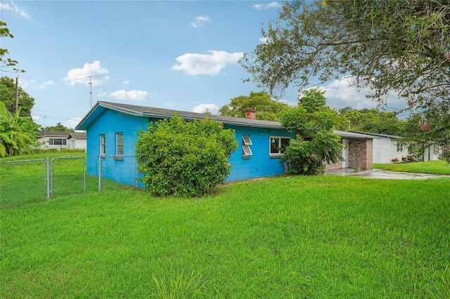 view of side of home with a yard