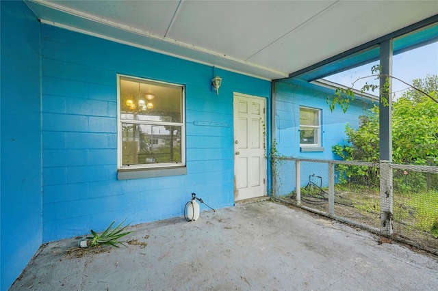 view of exterior entry with a patio