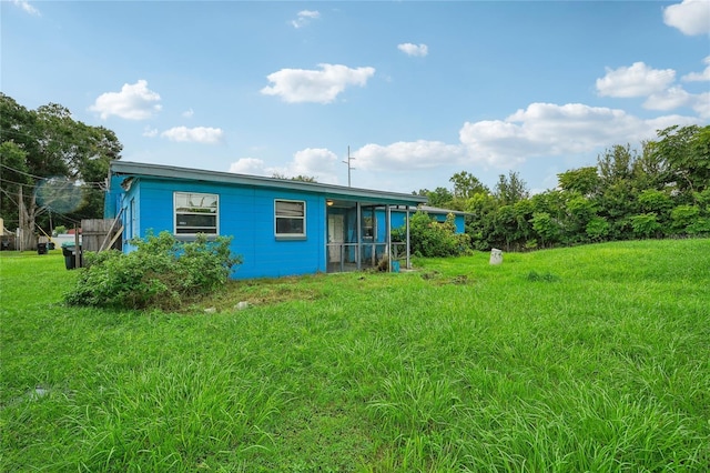 back of house featuring a lawn