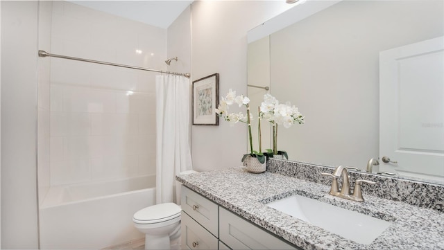 full bathroom featuring toilet, shower / bath combo with shower curtain, and vanity