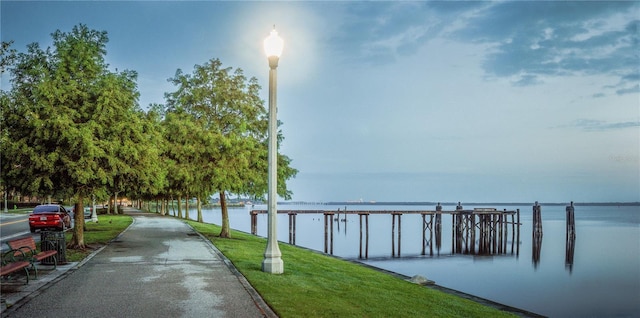 exterior space with a lawn and a water view