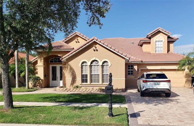 mediterranean / spanish home featuring a front lawn