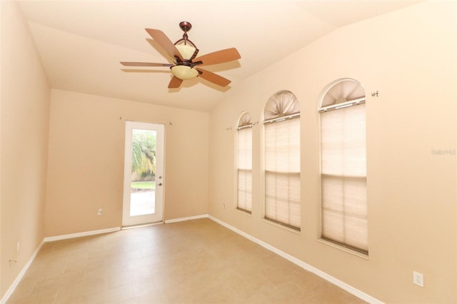 tiled empty room with lofted ceiling and ceiling fan