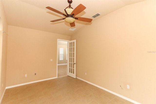 tiled empty room with lofted ceiling and ceiling fan