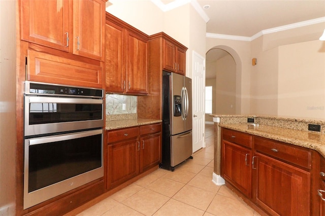 kitchen with crown molding, stainless steel appliances, light stone counters, and light tile patterned floors