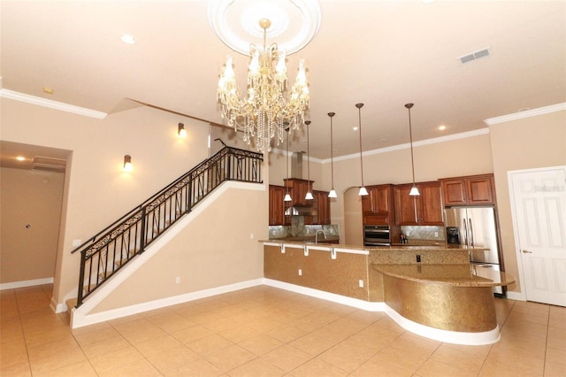 kitchen featuring crown molding, a chandelier, decorative light fixtures, stainless steel appliances, and kitchen peninsula