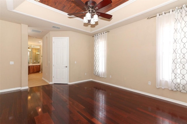 spare room featuring crown molding, ceiling fan, hardwood / wood-style floors, and a tray ceiling