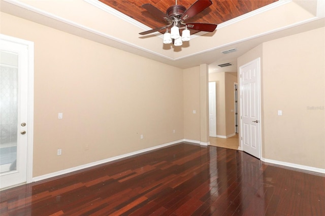 spare room featuring ceiling fan, wood ceiling, dark hardwood / wood-style floors, and crown molding