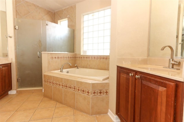 bathroom featuring vanity, a healthy amount of sunlight, tile patterned floors, and plus walk in shower