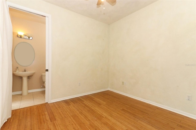 spare room with ceiling fan and hardwood / wood-style flooring