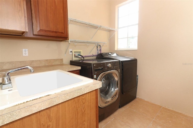 laundry room with light tile patterned floors, cabinets, sink, and independent washer and dryer