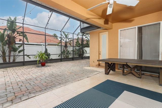 sunroom featuring ceiling fan