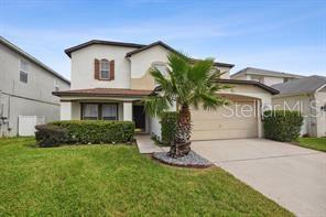 view of front facade with a front yard and a garage