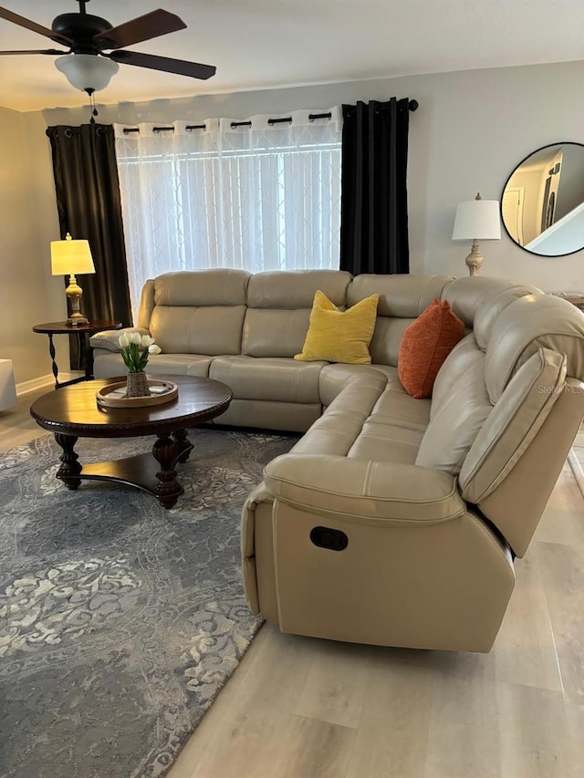 living room featuring ceiling fan and light wood-type flooring