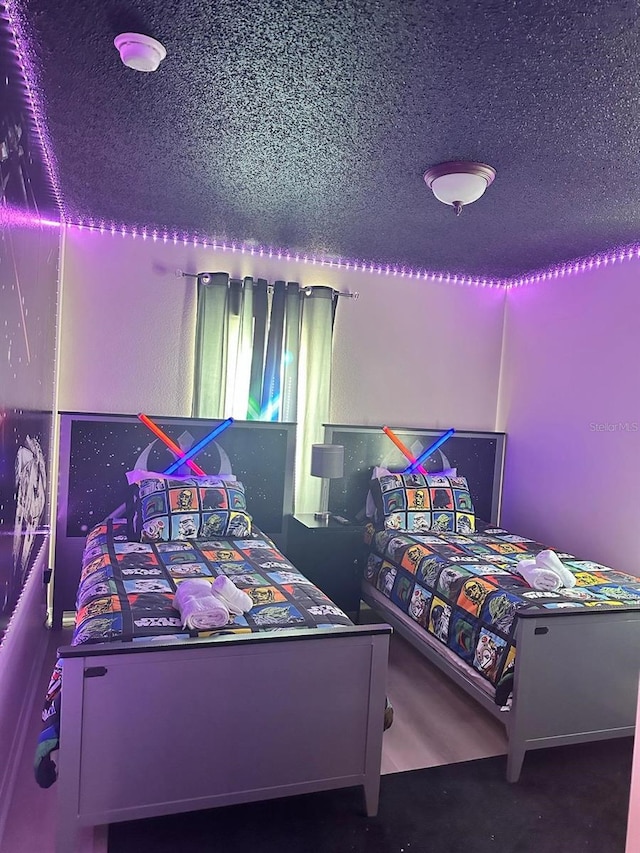 bedroom with a textured ceiling and carpet