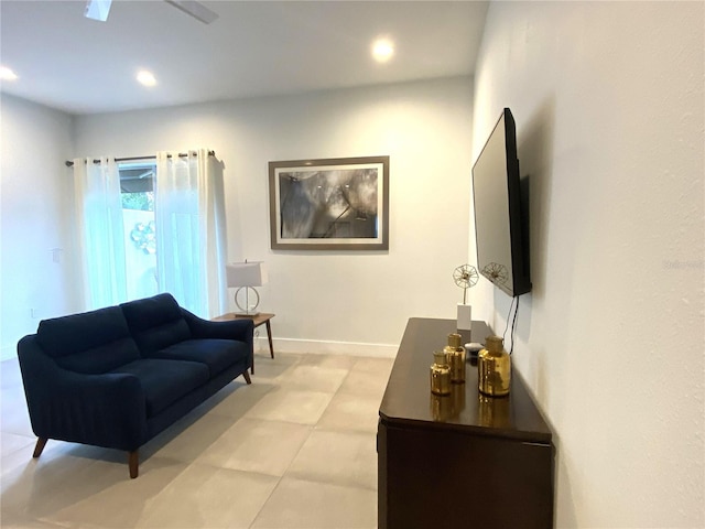 living room with ceiling fan and light tile patterned flooring