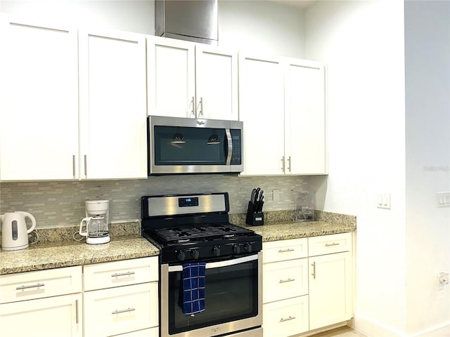 kitchen with tasteful backsplash, stainless steel appliances, and light stone countertops