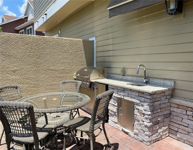 view of patio / terrace featuring sink, grilling area, and an outdoor kitchen