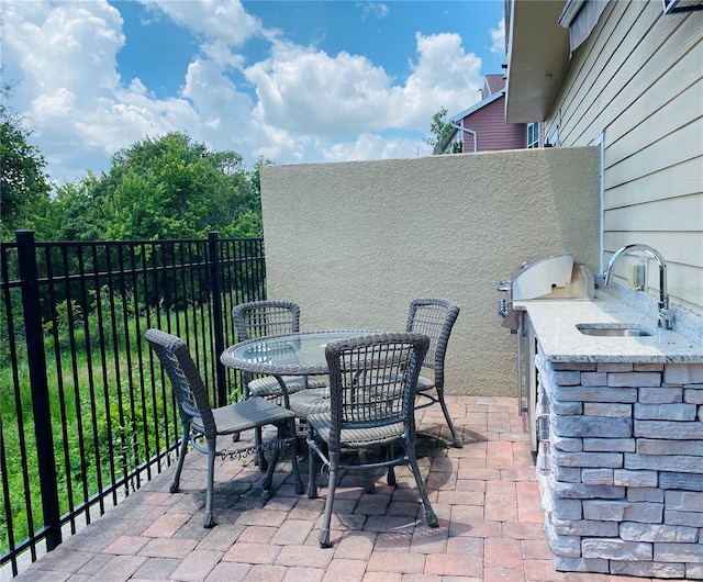 view of patio with exterior kitchen and sink