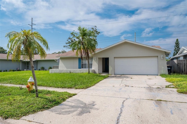 single story home featuring a garage and a front lawn