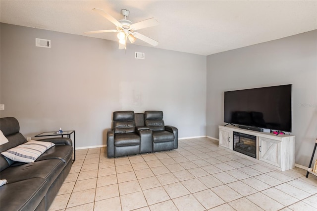 living room featuring light tile patterned floors and ceiling fan