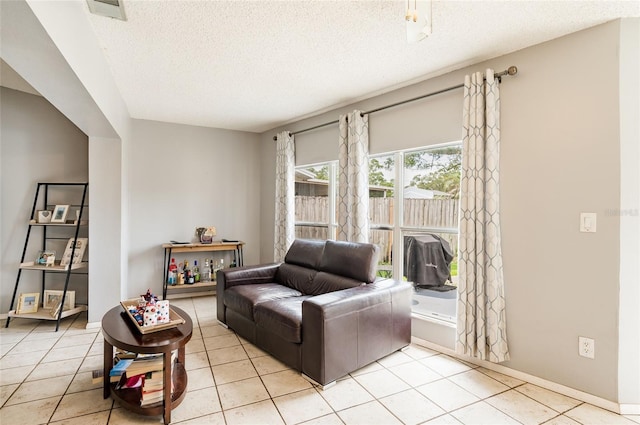 living room with light tile patterned floors and a textured ceiling