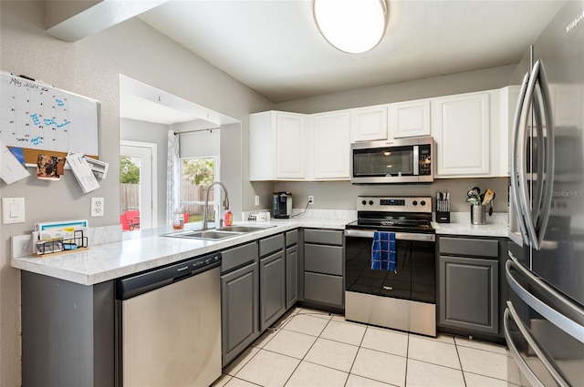 kitchen featuring gray cabinetry, stainless steel appliances, and kitchen peninsula