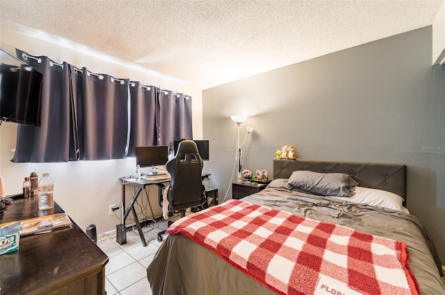 bedroom with a textured ceiling and light tile patterned flooring