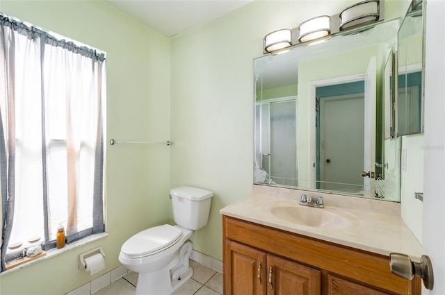 bathroom with toilet, tile patterned floors, and vanity