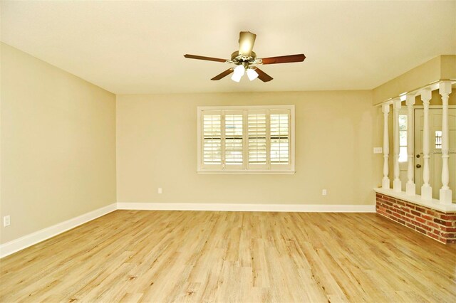 spare room with light wood-type flooring and ceiling fan