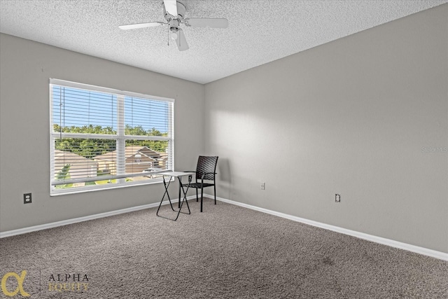 interior space featuring ceiling fan and a textured ceiling