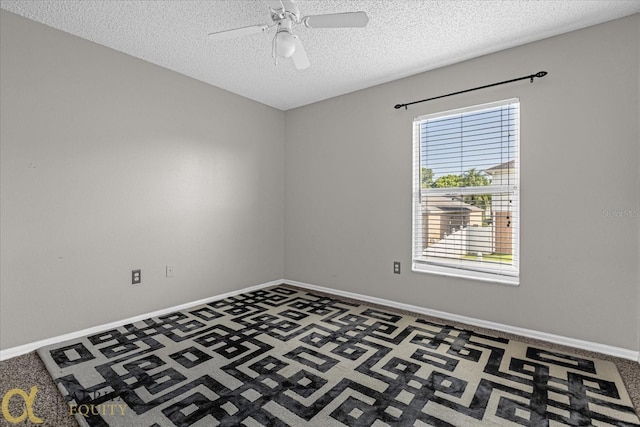 spare room with ceiling fan, a textured ceiling, and carpet floors