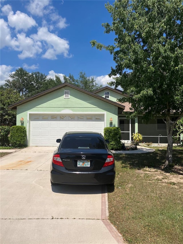 view of front of home with a garage and a front yard