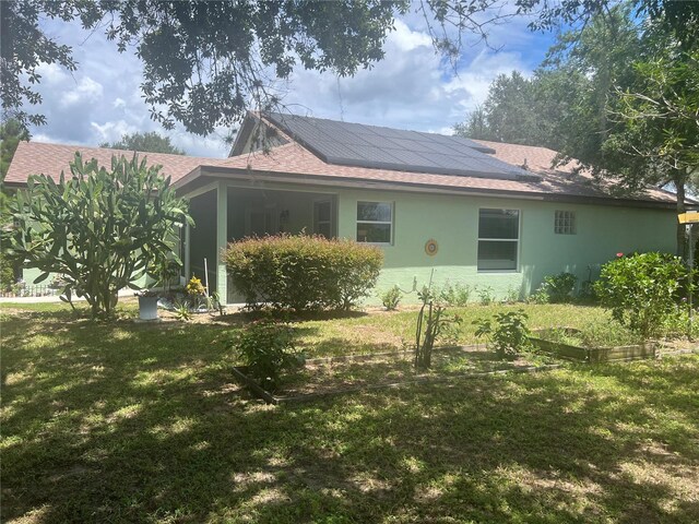 view of side of property with a lawn