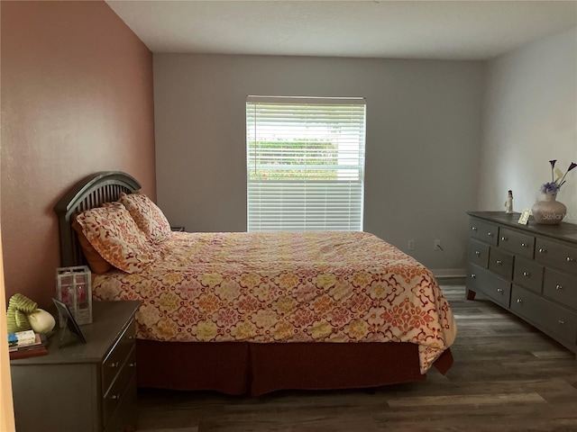 bedroom with dark hardwood / wood-style floors