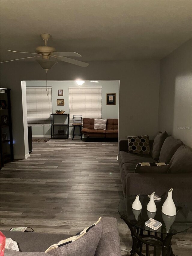 living room featuring hardwood / wood-style floors and ceiling fan