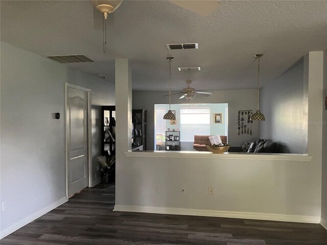 kitchen featuring a textured ceiling, dark wood-type flooring, and ceiling fan