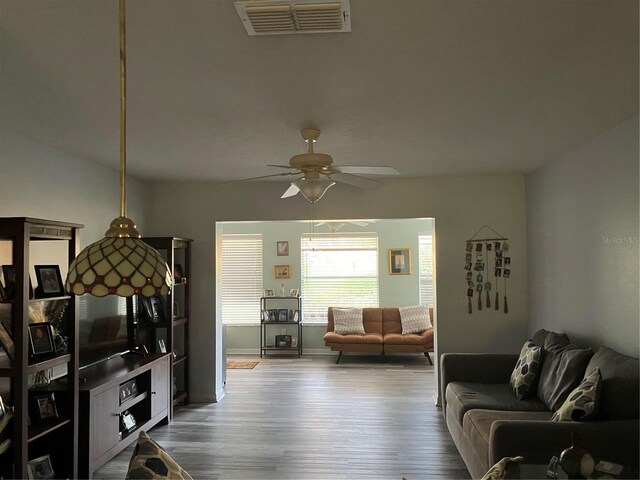 living room with hardwood / wood-style floors and ceiling fan