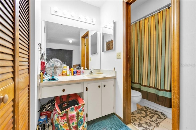 bathroom with vanity, toilet, and tile patterned flooring